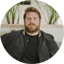 Ricky Schay, bearded, in a black jacket